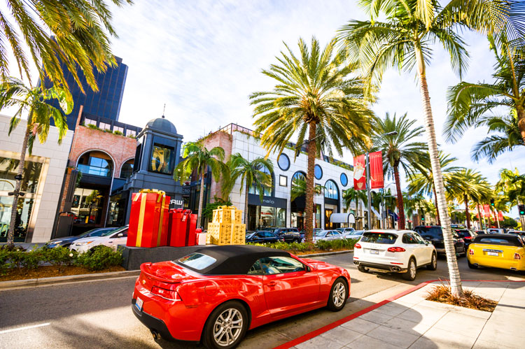 Luxury car driving on Rodeo Drive featured on a Hollywood Bus Tours route